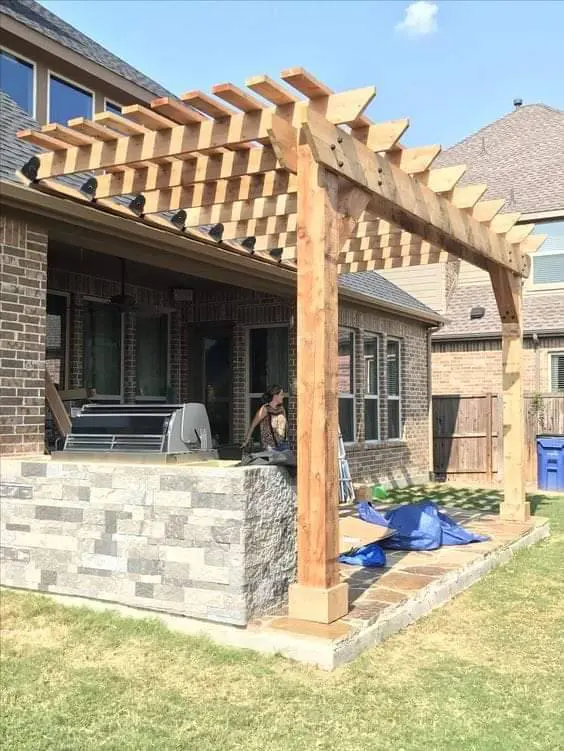 Pergola build with stone outdoor kitchen