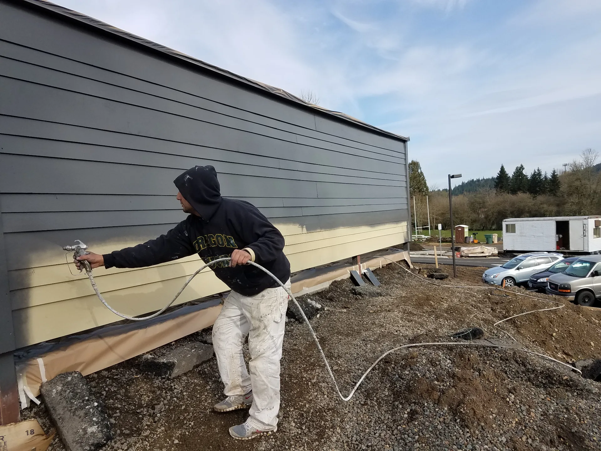 Siding spray painting in progress