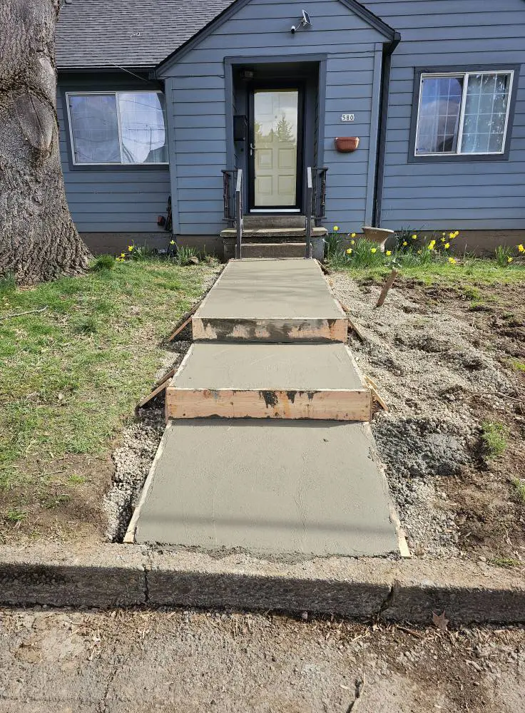 Freshly poured concrete walkway with steps