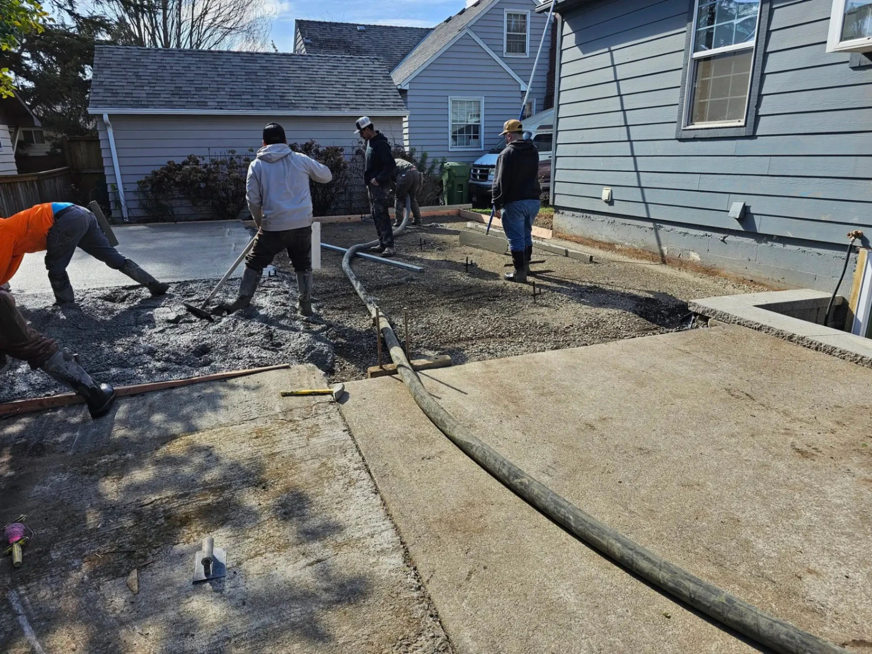 Crew pouring concrete driveway