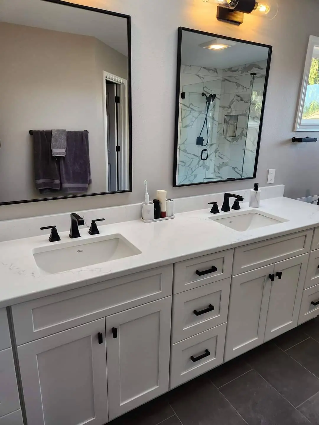 Double vanity with quartz top and black hardware