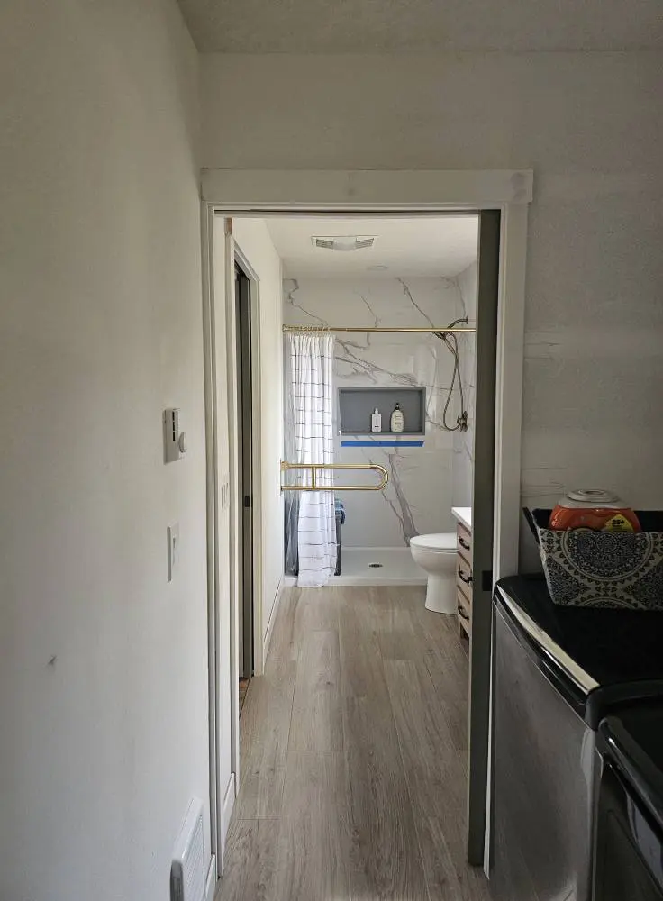 Hallway leading to completed bathroom remodel