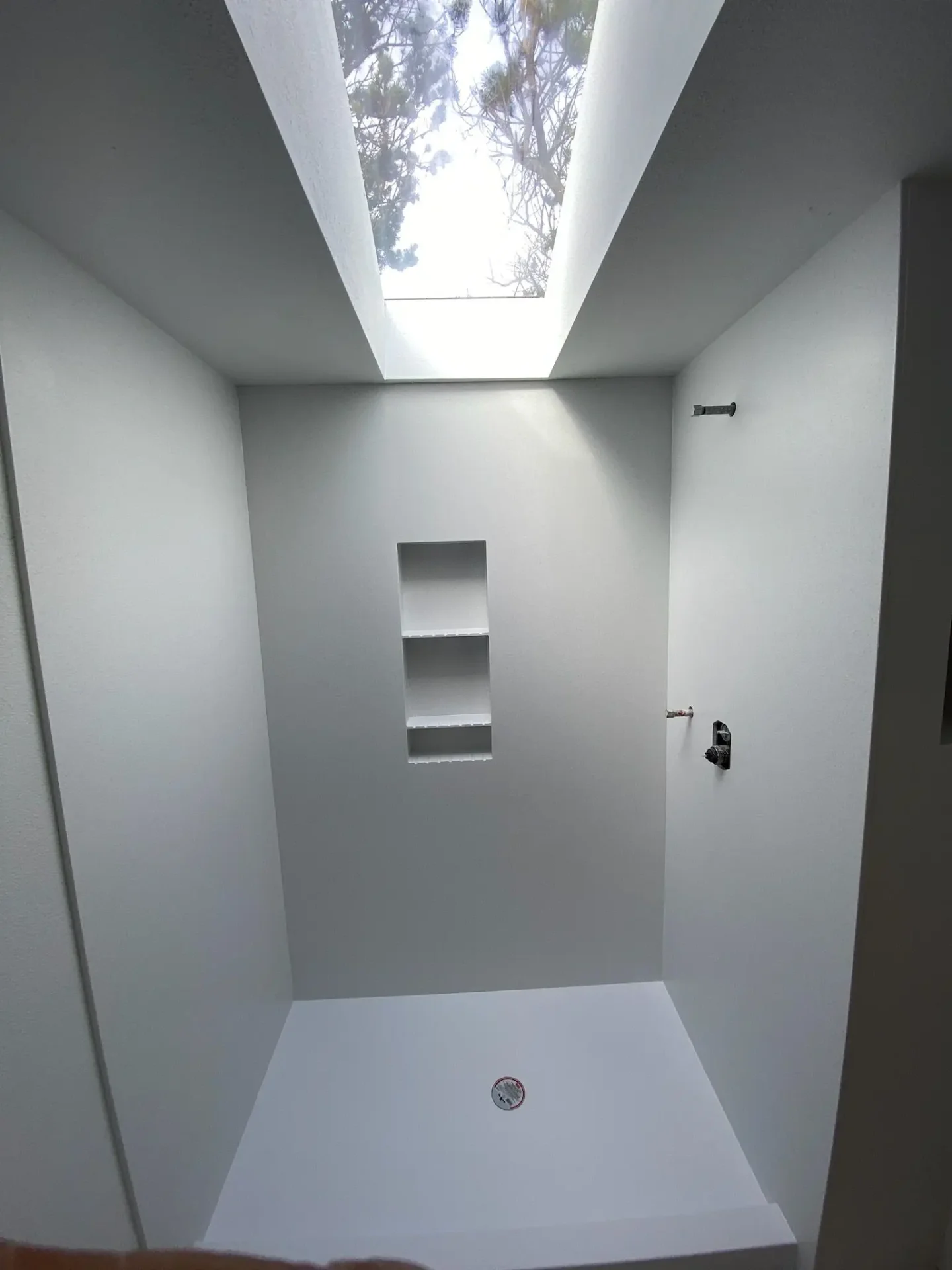 Custom shower with skylight and built-in niches