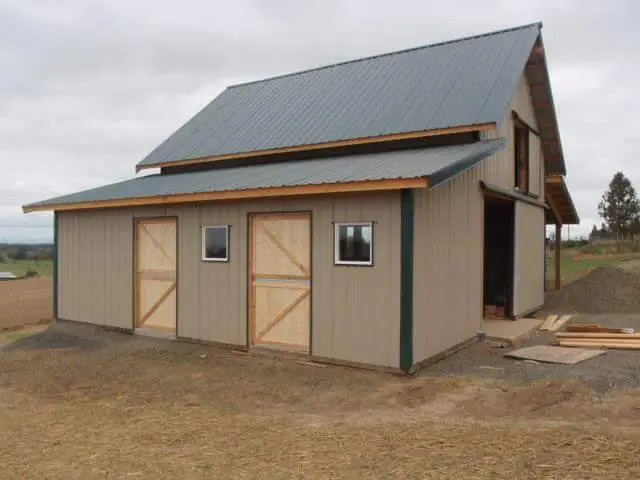 Completed pole barn with metal roof and Dutch doors