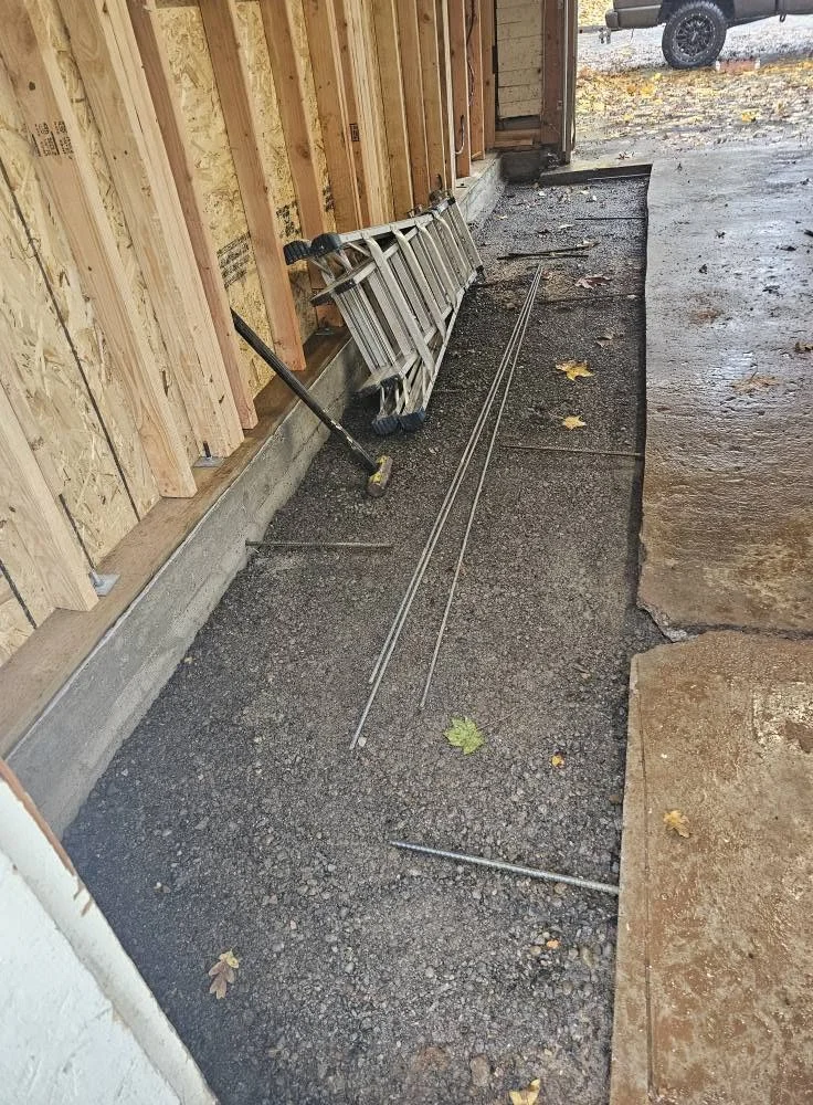 New concrete footing with rebar along garage wall