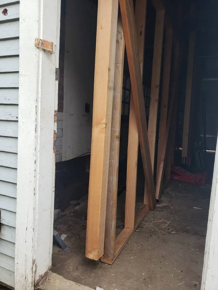 New wall framing braced inside garage rebuild