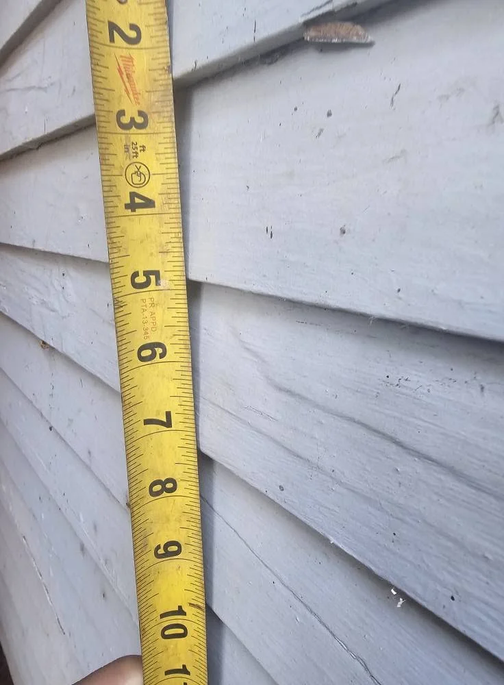 Siding detail showing repaired and replaced clapboards